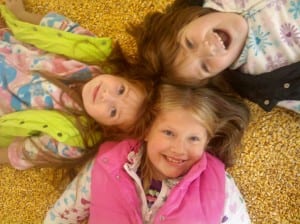 Girls laying in the corn